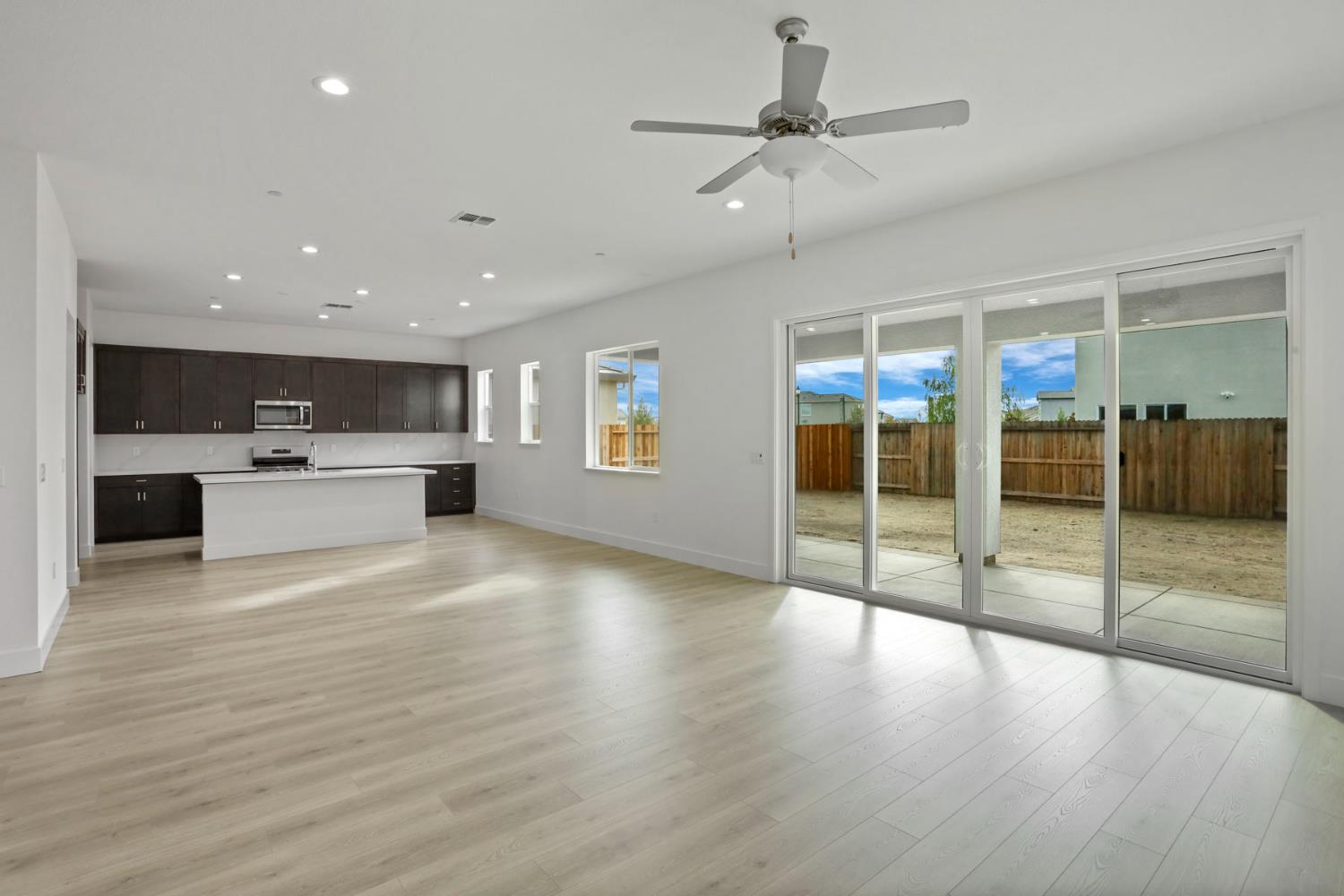 2291 Paramount Lane Manteca, CA 95337 - Photo 13 of 32 a view of a big room with wooden floor and windows
