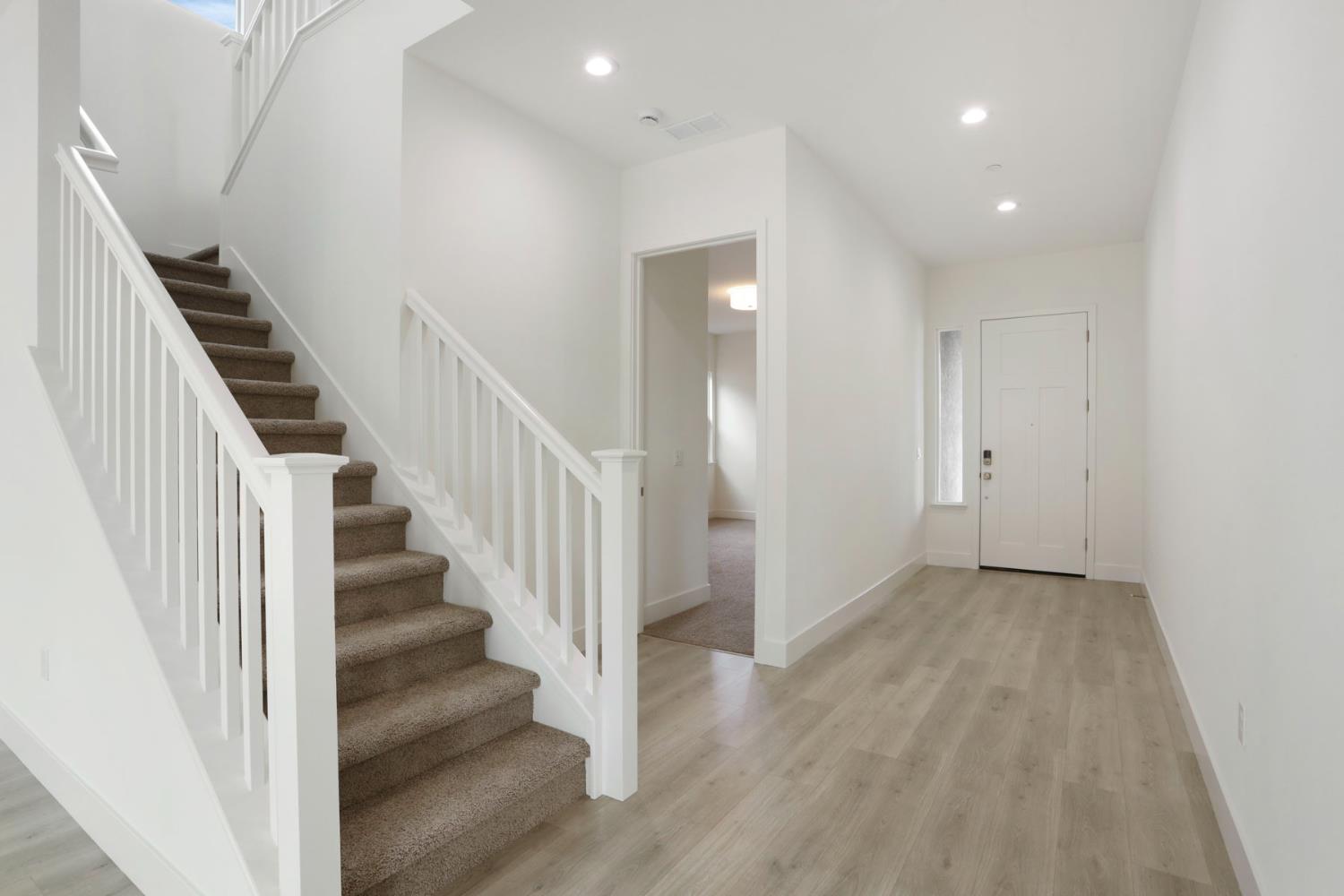 2291 Paramount Lane Manteca, CA 95337 - Photo 21 of 34 a view of a hallway with wooden floor and entryway