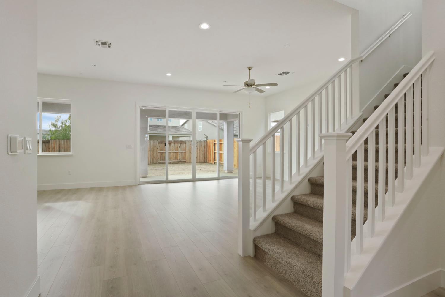 2291 Paramount Lane Manteca, CA 95337 - Photo 23 of 32 a view of staircase with wooden floor and floor to ceiling window