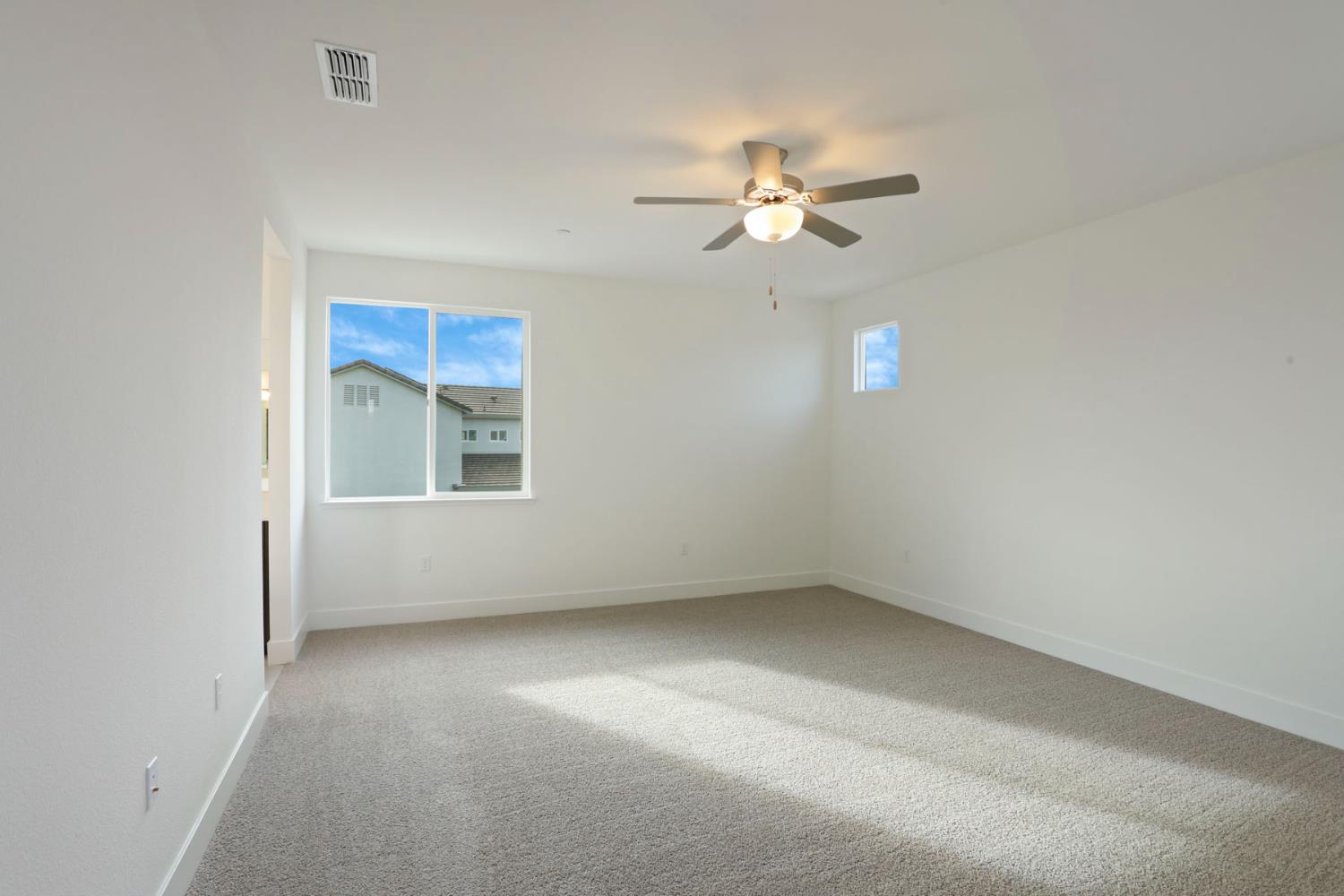 2291 Paramount Lane Manteca, CA 95337 - Photo 26 of 32 an empty room with a window and ceiling fan