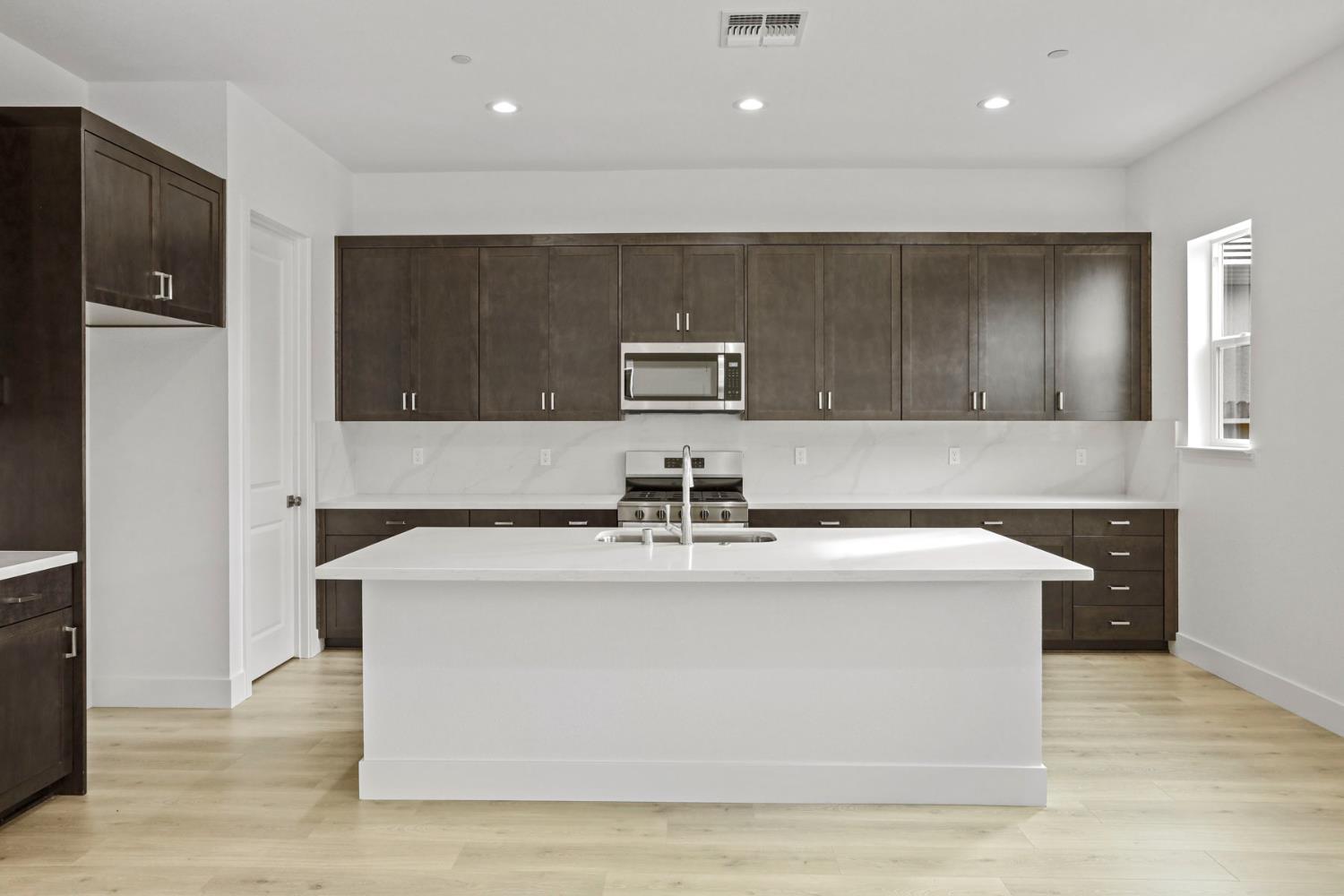 2291 Paramount Lane Manteca, CA 95337 - Photo 6 of 34 a view of living room with stainless steel appliances granite countertop cabinets and wooden floor