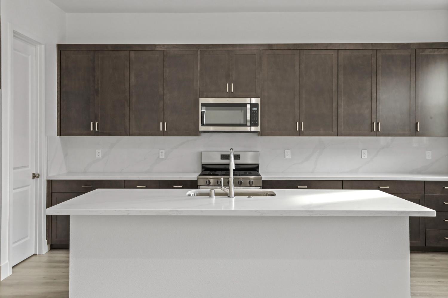 2291 Paramount Lane Manteca, CA 95337 - Photo 6 of 32 a kitchen with a sink and cabinets