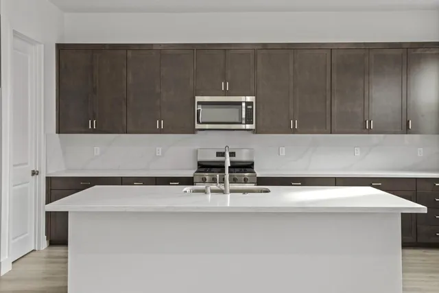 a kitchen with a sink and cabinets