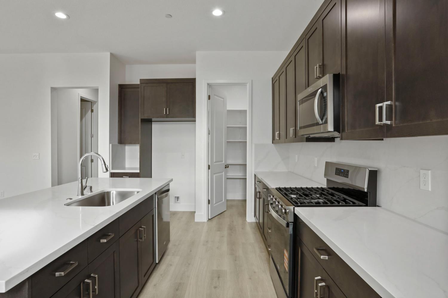 2291 Paramount Lane Manteca, CA 95337 - Photo 8 of 32 a kitchen with stainless steel appliances a sink stove and cabinets