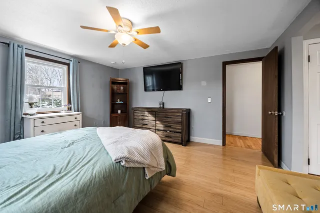 a bedroom with bed and window