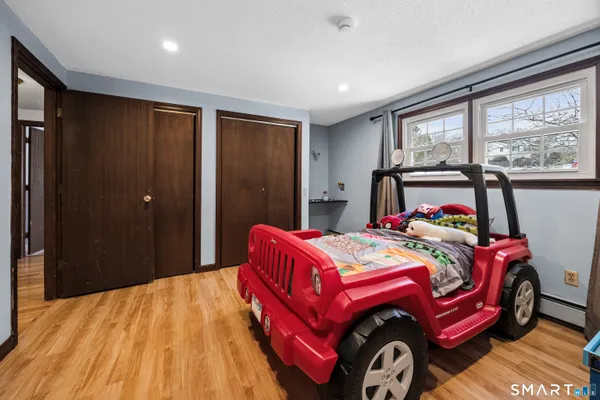 a bedroom with a bed and a window