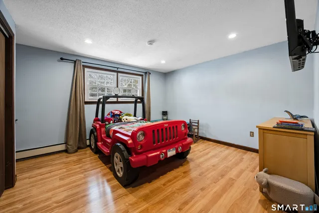 a kitchen with refrigerator a sink and wooden floor