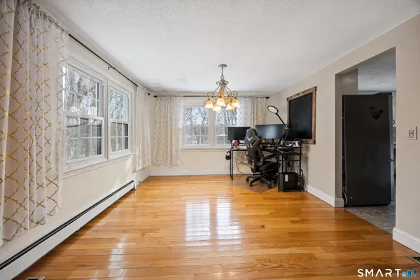 a view of a dining room with furniture and a chandelier