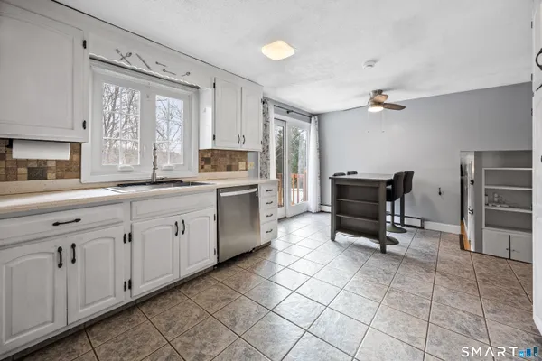a kitchen with a sink appliances and cabinets