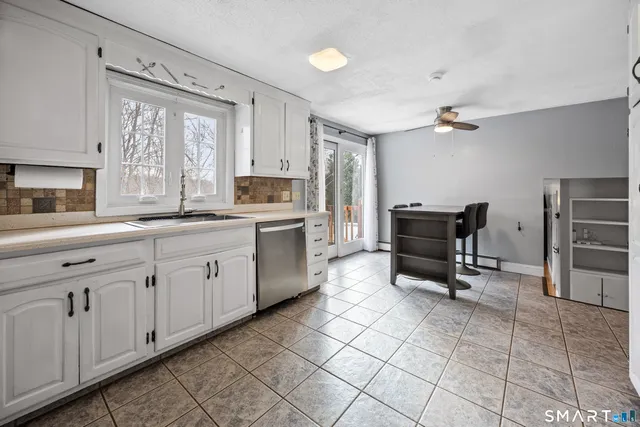 a kitchen with a sink appliances and cabinets
