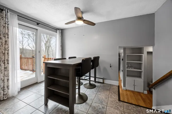 a view of a workspace with furniture and a window