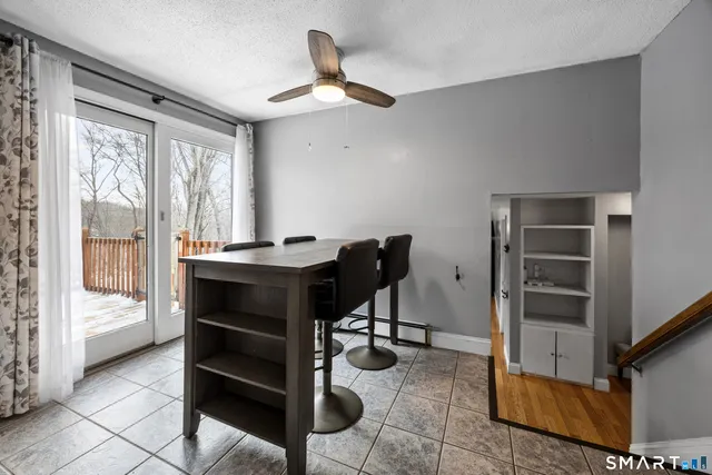 a view of a workspace with furniture and a window