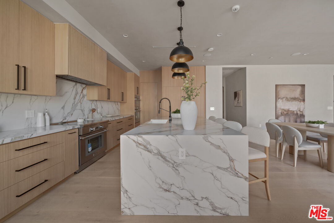 11317 Valley Spring Lane Studio City, CA 91602 - Photo 18 of 44 a kitchen with sink and cabinets