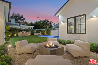11317 Valley Spring Lane Studio City, CA 91602 - Photo 23 of 44 a front view of a house with backyard sitting area and garden
