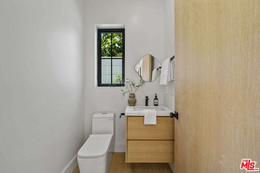 11317 Valley Spring Lane Studio City, CA 91602 - Photo 29 of 44 a bathroom with a toilet sink and mirror