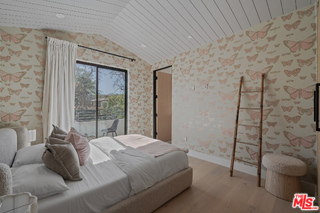 11317 Valley Spring Lane Studio City, CA 91602 - Photo 37 of 44 a bed sitting in a spacious bedroom next to a window