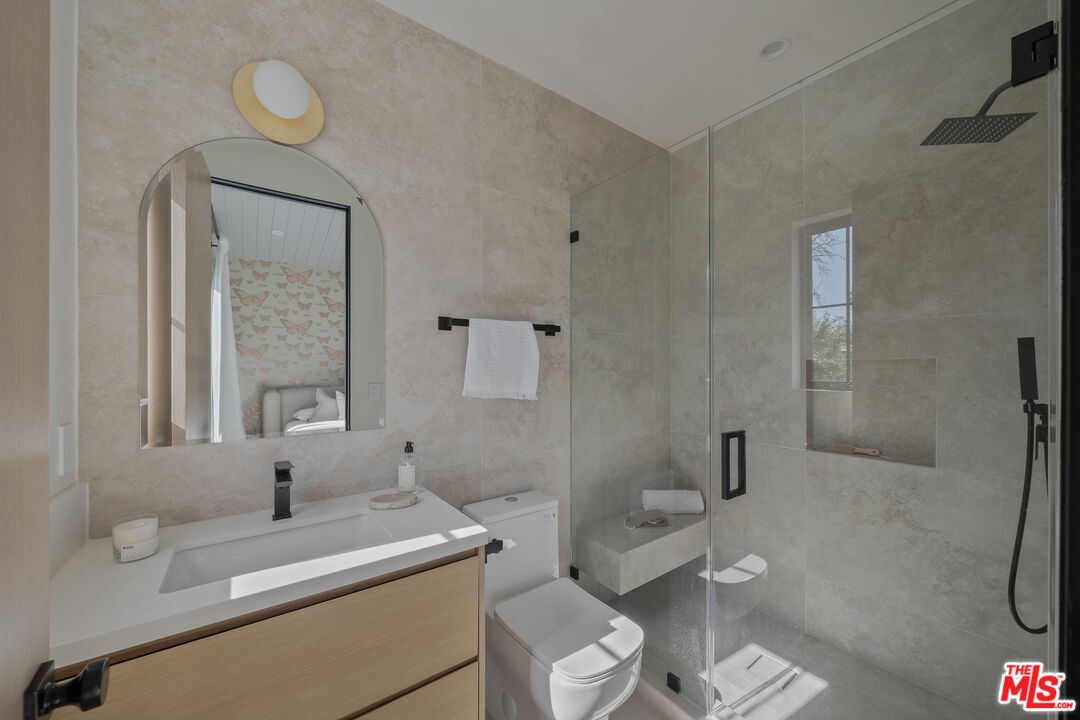 11317 Valley Spring Lane Studio City, CA 91602 - Photo 39 of 44 a bathroom with a sink toilet and shower