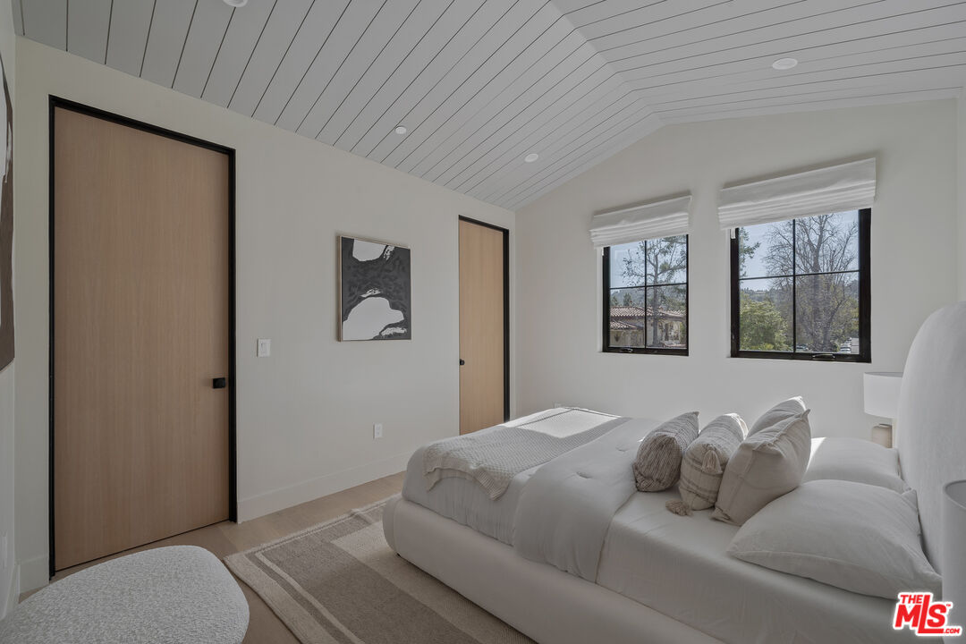 11317 Valley Spring Lane Studio City, CA 91602 - Photo 40 of 44 a bedroom with a bed and a window