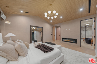 11317 Valley Spring Lane Studio City, CA 91602 - Photo 4 of 44 a bedroom with a bed and a chandelier