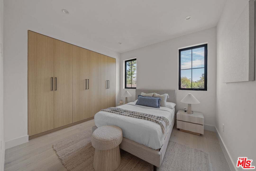 11317 Valley Spring Lane Studio City, CA 91602 - Photo 42 of 44 a bedroom with a bed and a lamp