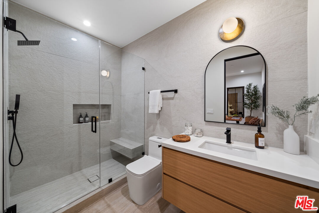 11317 Valley Spring Lane Studio City, CA 91602 - Photo 10 of 44 a bathroom with a sink a toilet and shower