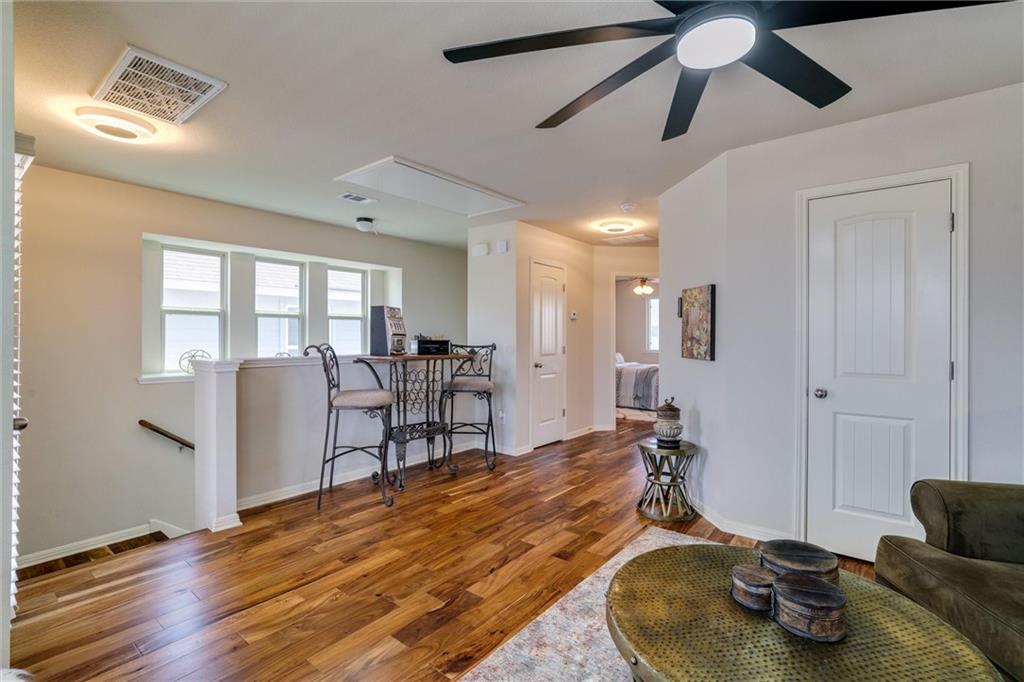 4606 Kind Way, Unit 285 Austin, TX 78725 - Photo 6 of 14 The property features hardwood floors, a ceiling fan, and white paneled doors