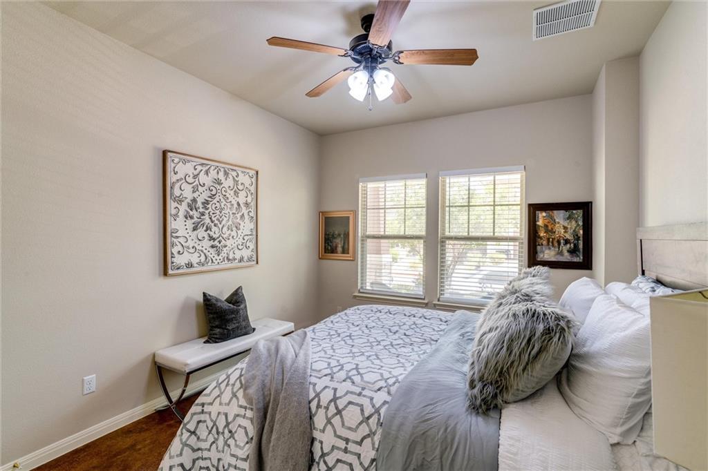 4606 Kind Way, Unit 285 Austin, TX 78725 - Photo 7 of 14 This room features a vaulted ceiling with a ceiling fan, two windows with blinds, and hardwood floors