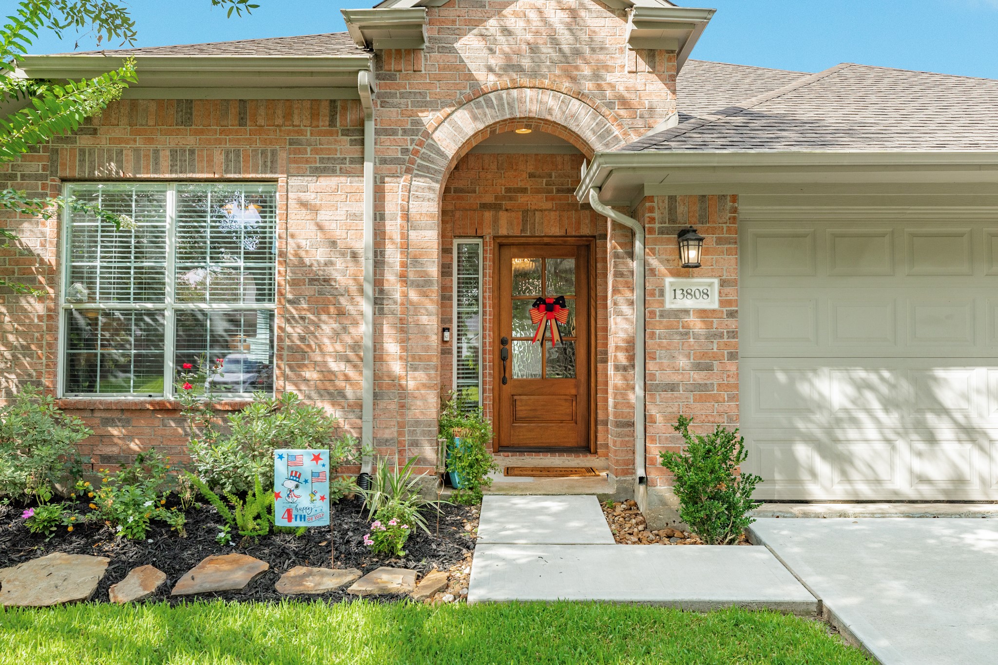 13808 Stark Bridge Lane Rosharon, TX 77583 - Photo 2 of 39 This home showcases a stunning new wooden front door featuring elegant frosted glass, providing the perfect finishing touch to this beautiful property.