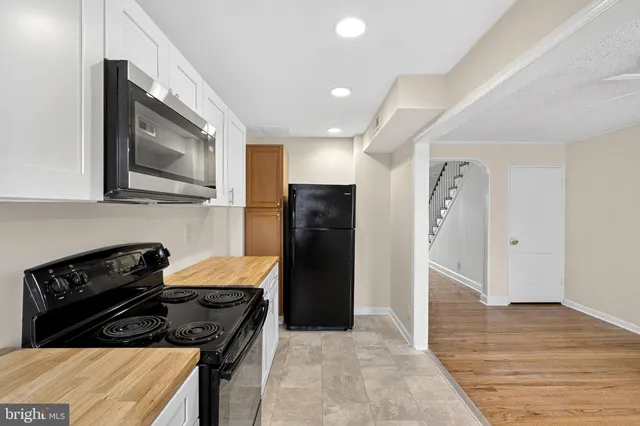 a kitchen with a stove and a refrigerator