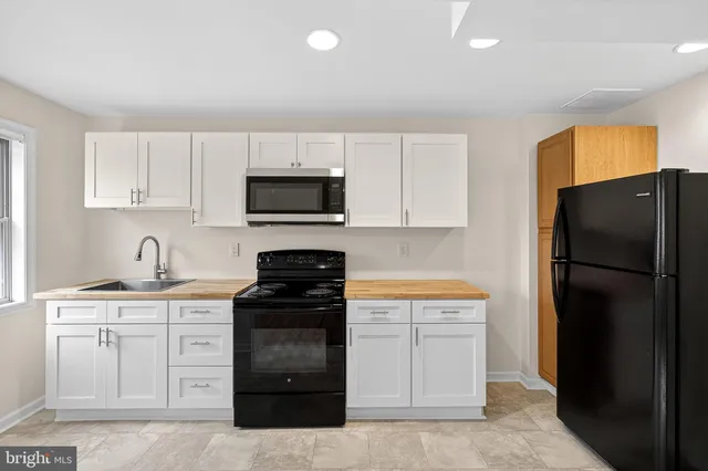 a kitchen with a refrigerator stove and microwave
