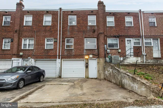 a couple of cars parked in front of a building