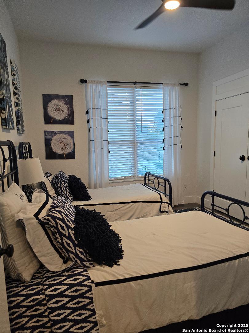 451 Legion Loop Kingsland, TX 78639 - Photo 13 of 23 a bathroom with a granite countertop sink and a large mirror