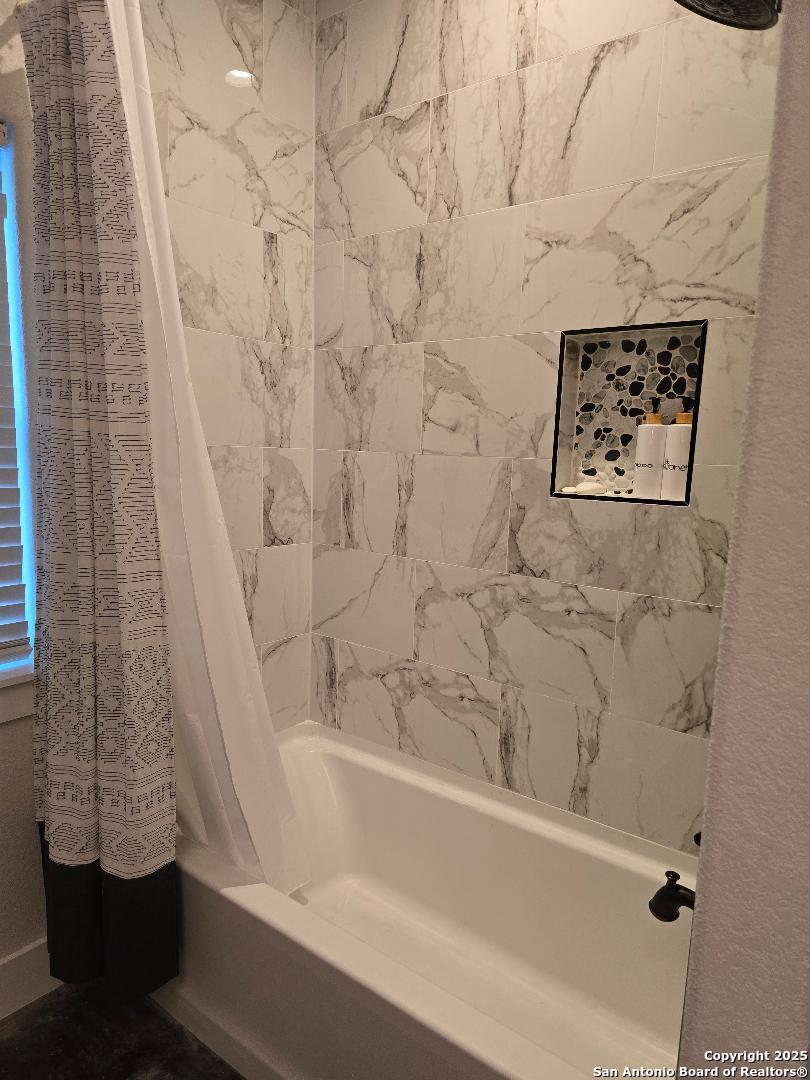 451 Legion Loop Kingsland, TX 78639 - Photo 14 of 23 a bathroom with a bathtub and shower