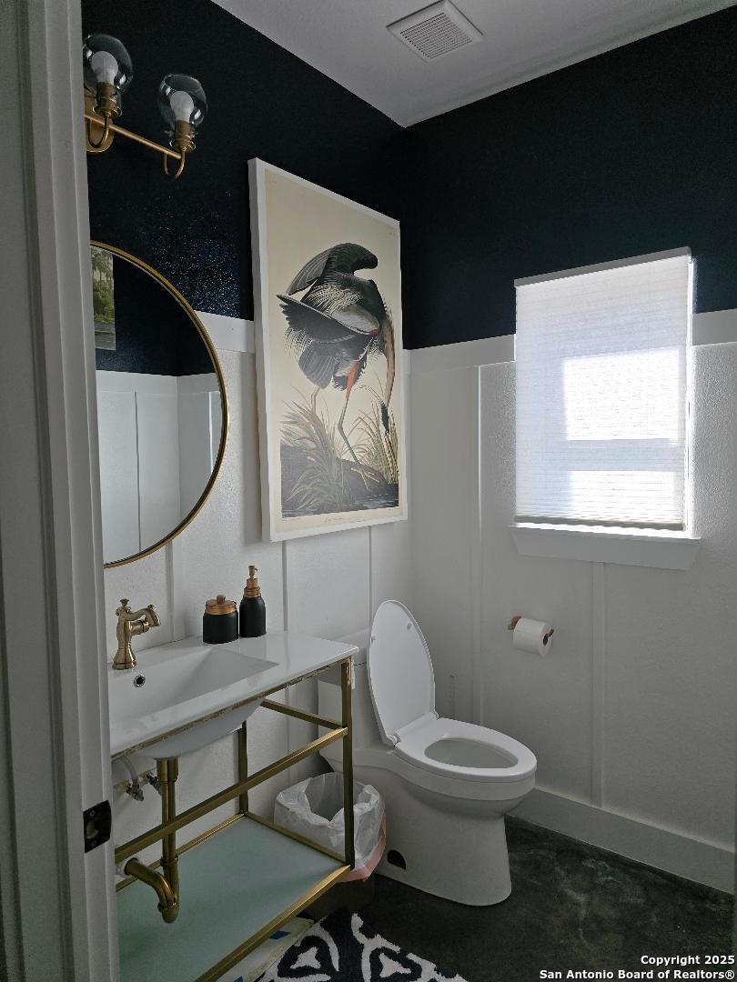 451 Legion Loop Kingsland, TX 78639 - Photo 19 of 23 a bathroom with a toilet a sink and mirror