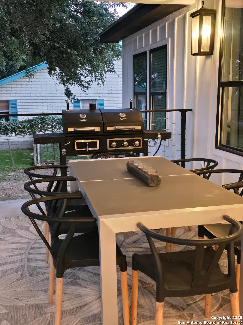 451 Legion Loop Kingsland, TX 78639 - Photo 23 of 23 a view of a patio with table and chairs a barbeque with wooden floor and fence