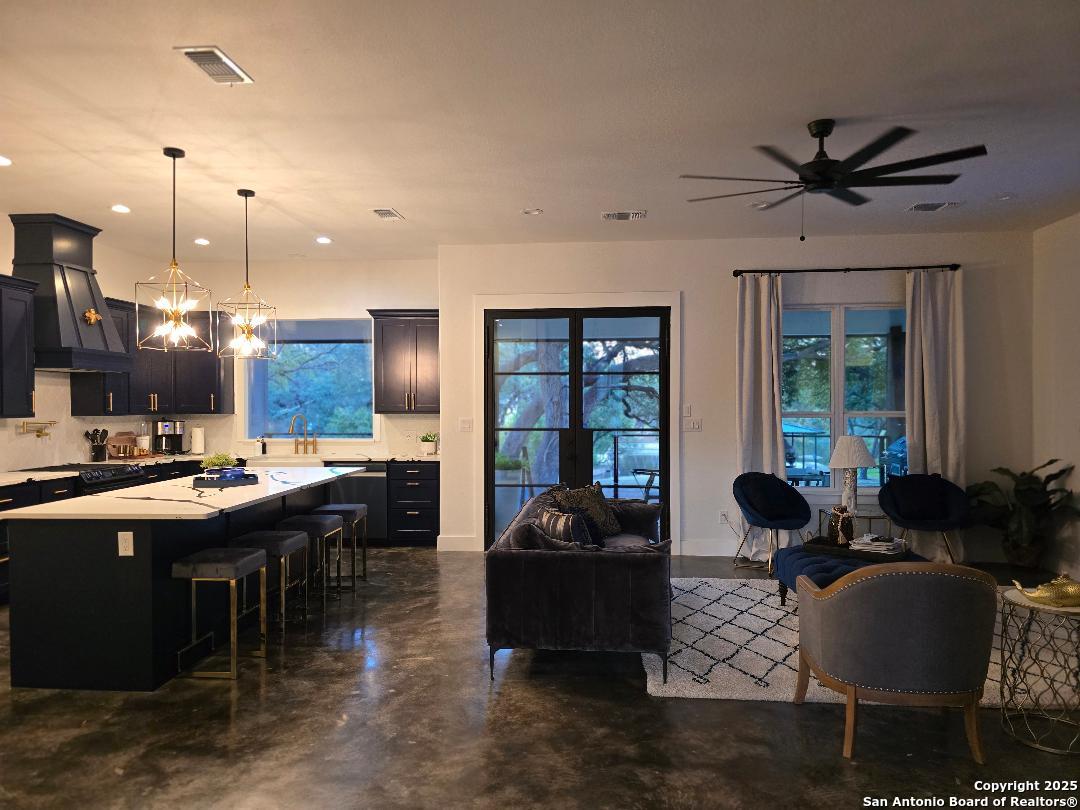 451 Legion Loop Kingsland, TX 78639 - Photo 3 of 23 a living room with furniture kitchen view and a large window