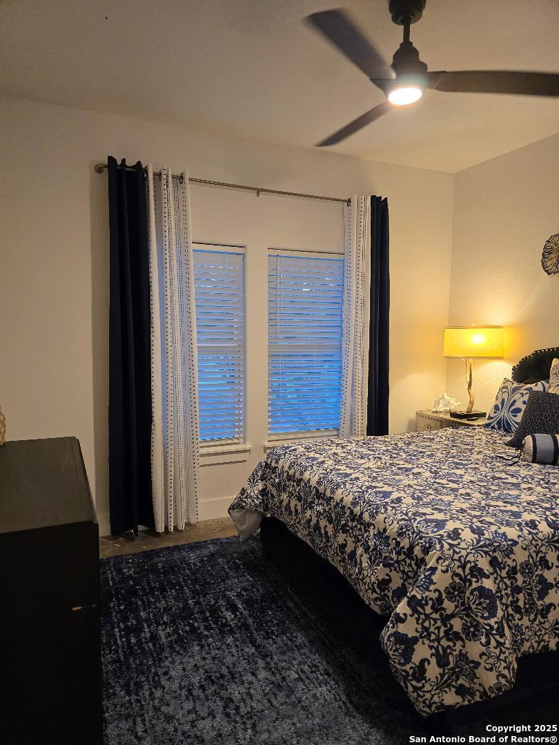 451 Legion Loop Kingsland, TX 78639 - Photo 8 of 23 a bed sitting in a bedroom next to a window and dresser