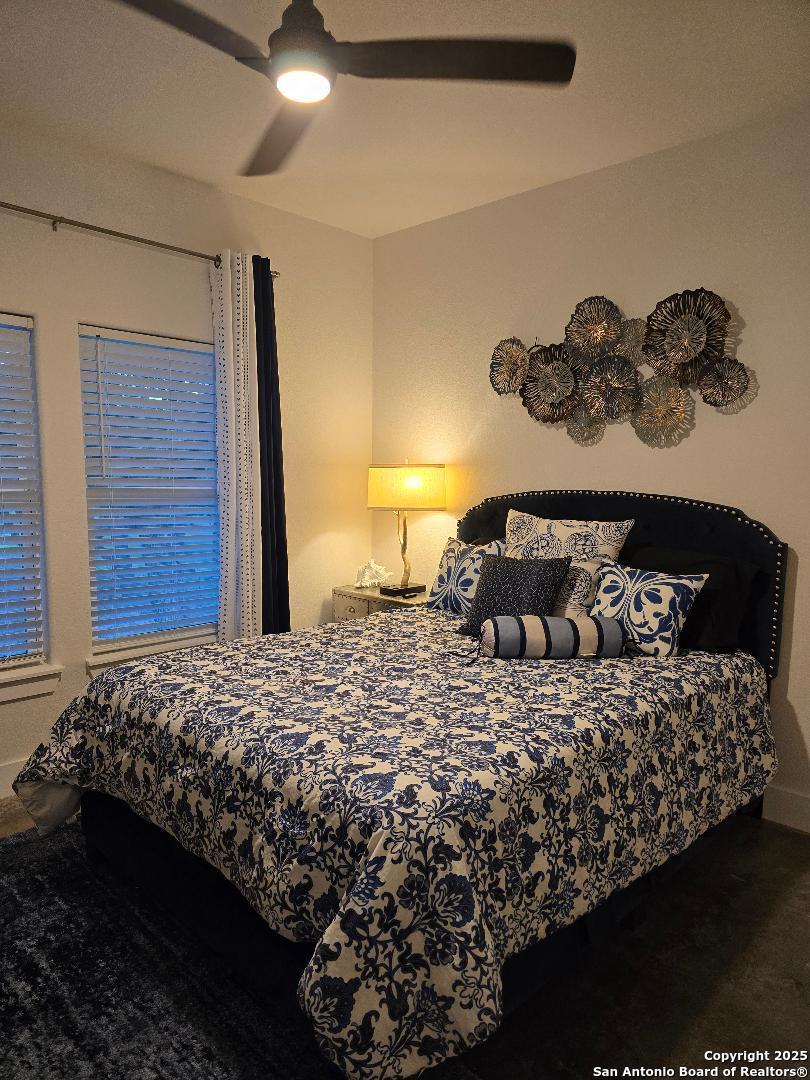 451 Legion Loop Kingsland, TX 78639 - Photo 10 of 23 a bedroom with a bed and a table