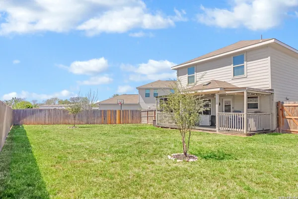 a house view with swimming pool and garden space