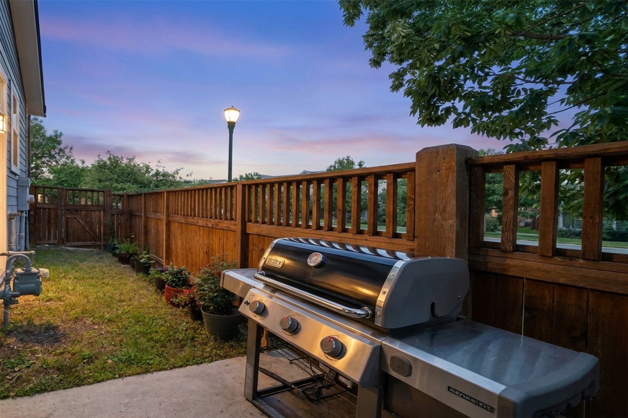 3901 Vaughan Street Austin, TX 78723 - Photo 33 of 37 Private fenced yard featuring a concrete patio, grassy area, and wood privacy fencing