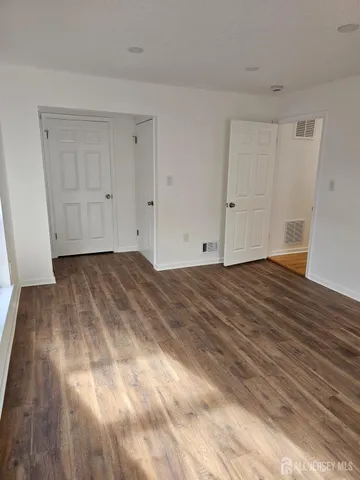 a view of room with wooden floor