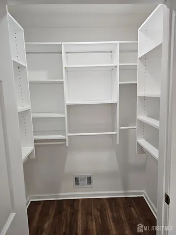 a view of walk in closet with empty racks
