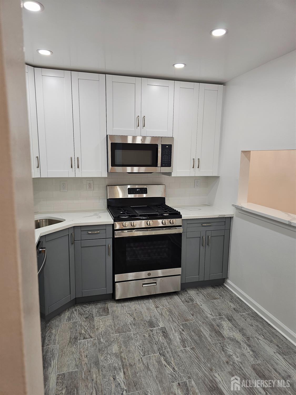 21 Brighton Way North Brunswick, NJ 08902 - Photo 8 of 20 a kitchen with granite countertop a stove and a sink
