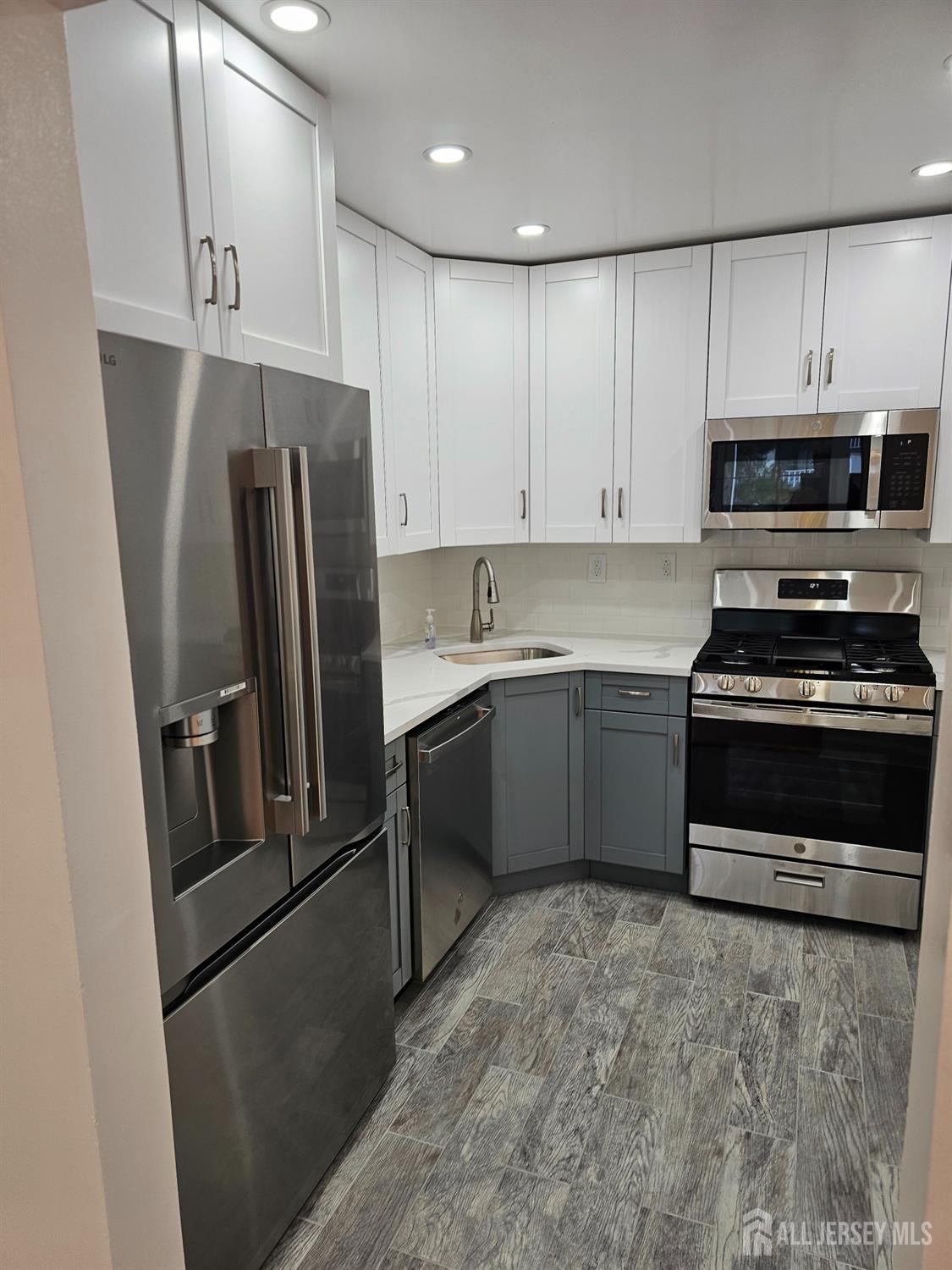 21 Brighton Way North Brunswick, NJ 08902 - Photo 9 of 20 a kitchen with stainless steel appliances a refrigerator sink and cabinets
