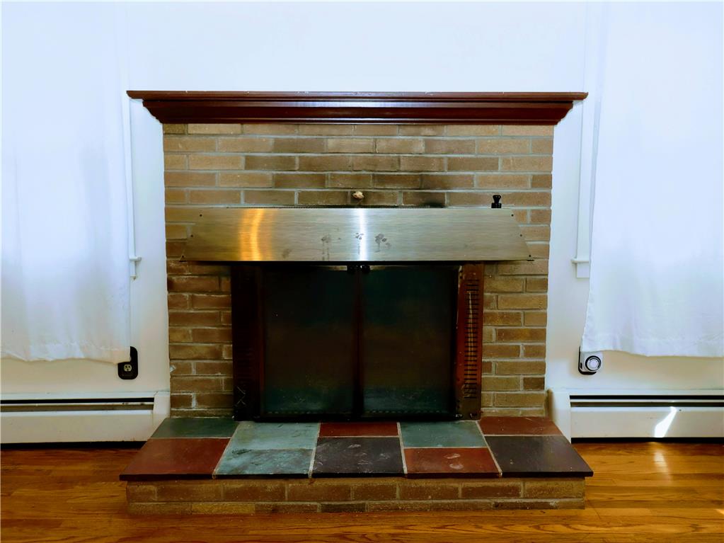 172 Harrison Street Emmaus, PA 18049 - Photo 3 of 30 A classic brick fireplace with a colorful tile hearth anchors this living space.