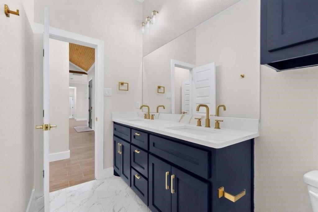 335 Cross Tie Ranch Road Trinidad, TX 75163 - Photo 26 of 30 Double vanity with a white countertop and gold-finish fixtures