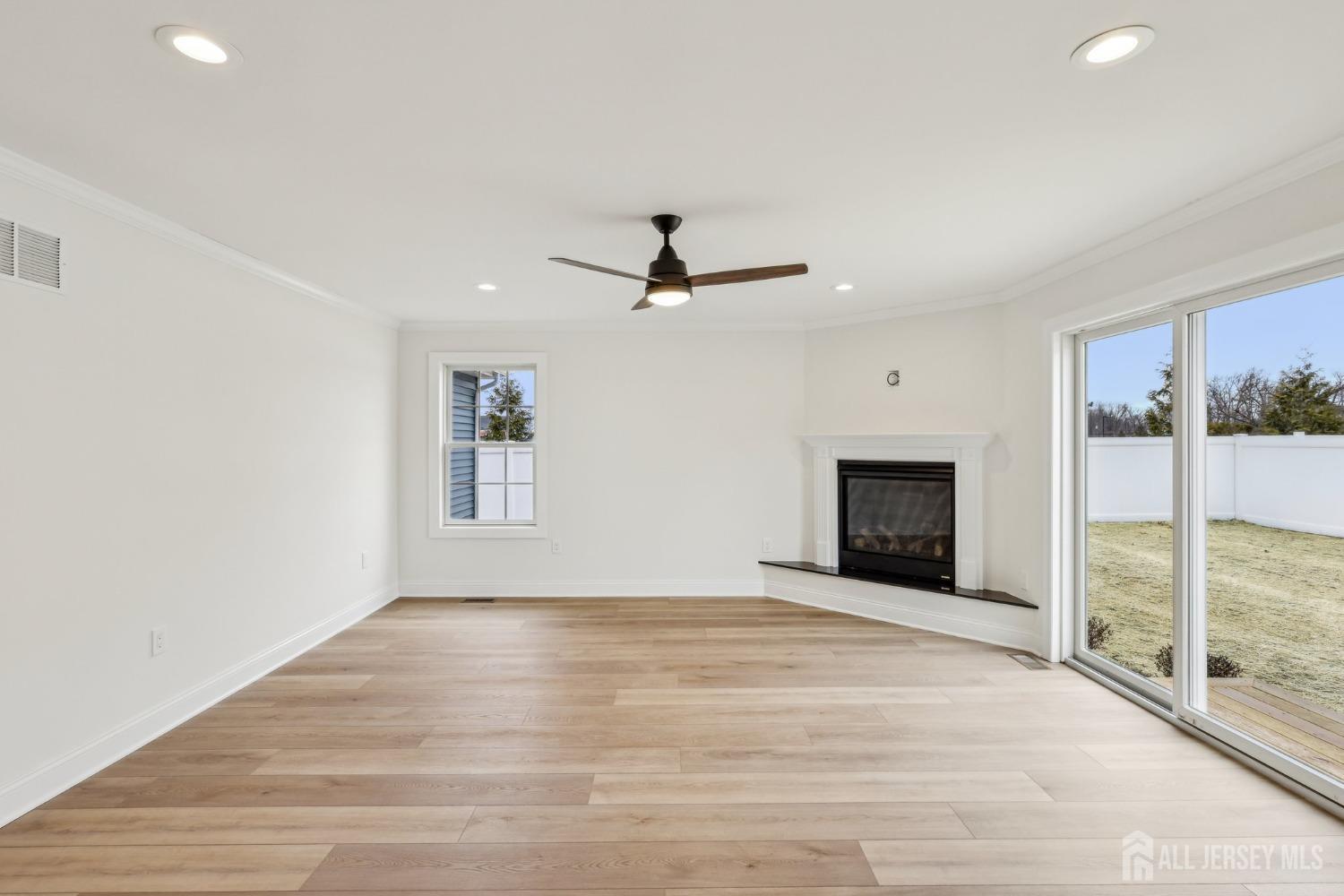 559 Holmdel Road Hazlet, NJ 07730 - Photo 8 of 52 a view of an empty room with a fireplace and a window