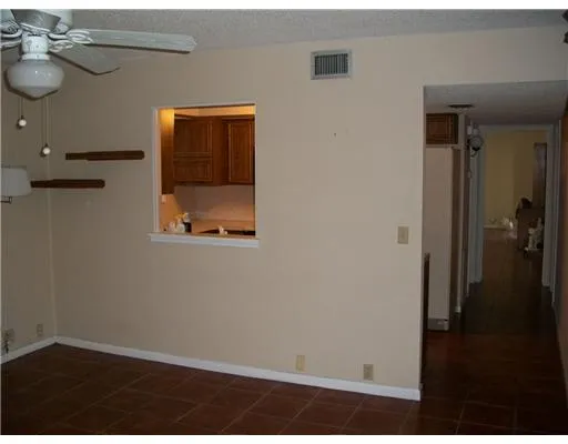 a kitchen with a sink a refrigerator and cabinets