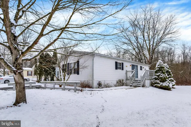 a view of a house with a snow in the yard