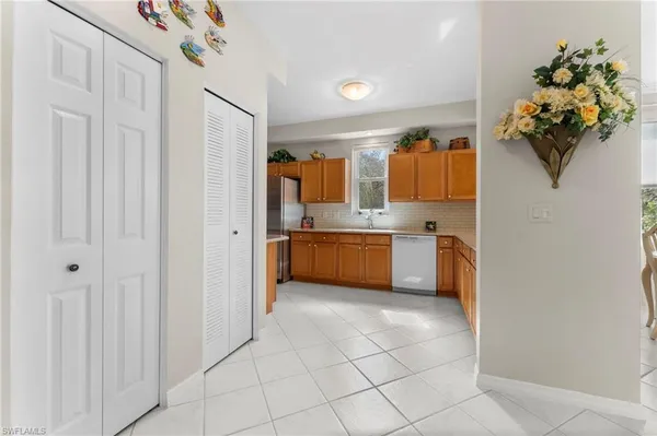 a white kitchen with a sink a counter top space and cabinets